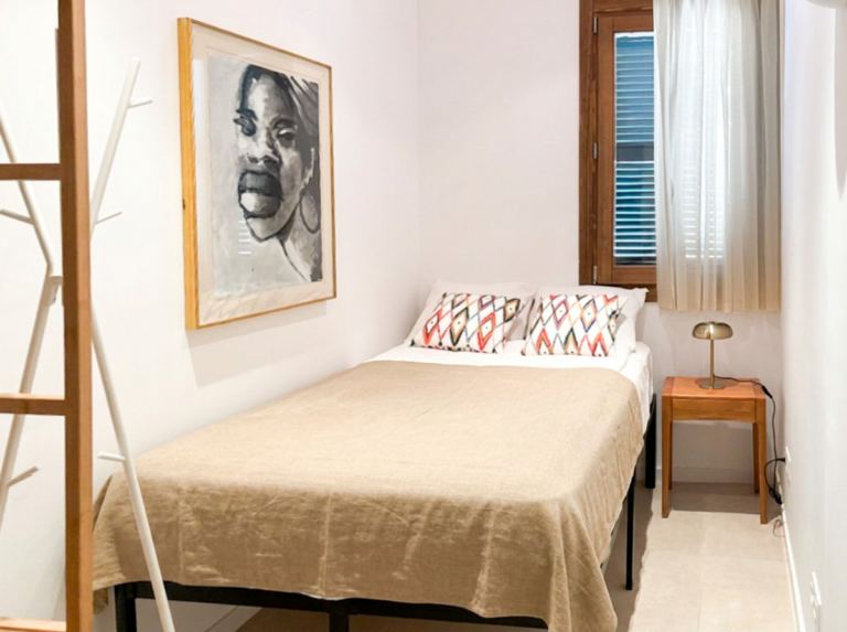 Small double bedroom with art